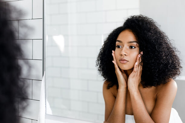 young woman looking at the mirror